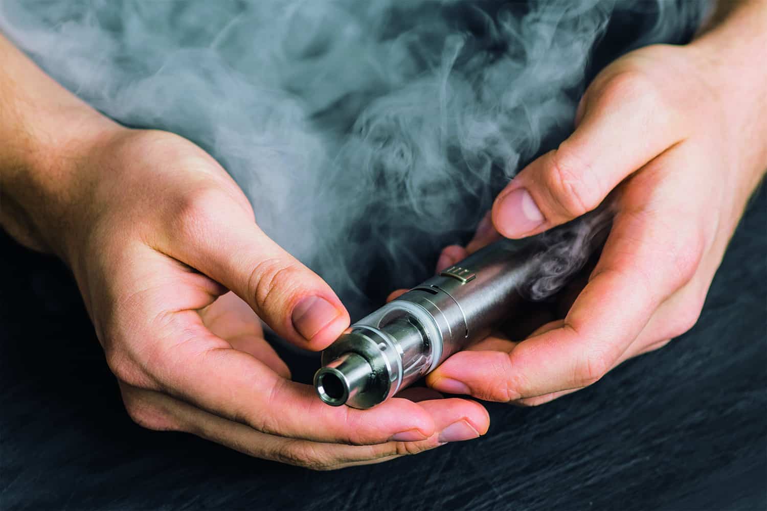 Close-up of vaper in hands