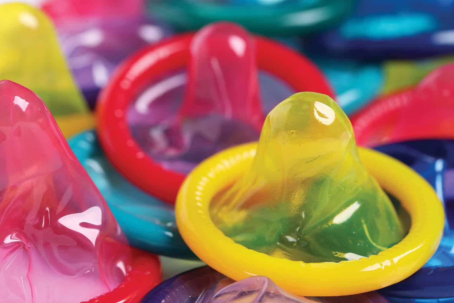 Close-up of brightly coloured condoms.