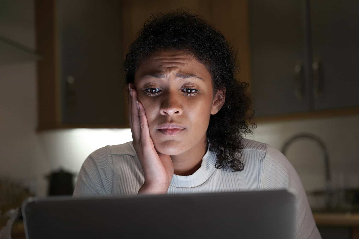 a woman looking scared at the computer