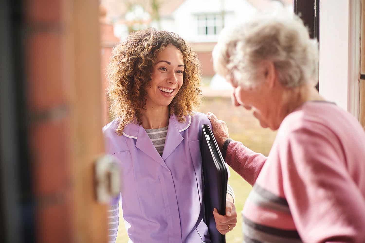 Female healthcare assistant visiting an elderly woman.