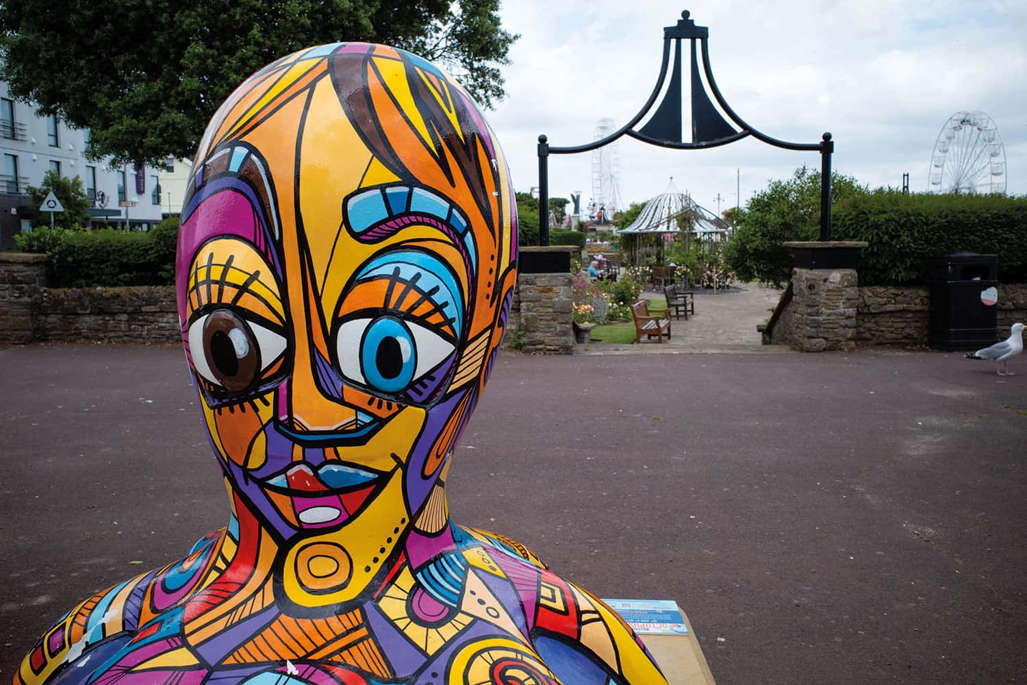 photo of psychedelic multi-coloured art installation in seaside town park