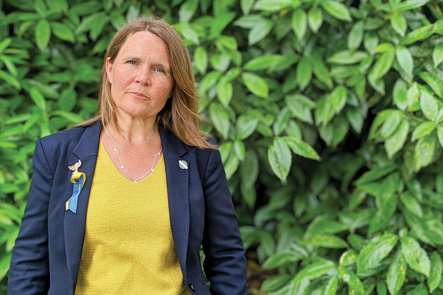 photo of Cllr Vikki Slade MP, Liberal Democrat Spokesperson for Housing, Communities and Local Government, outside against a leafy green background